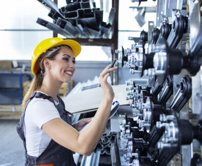 woman-industrial-employee-working-uniform-hardhat-checking-production-factory